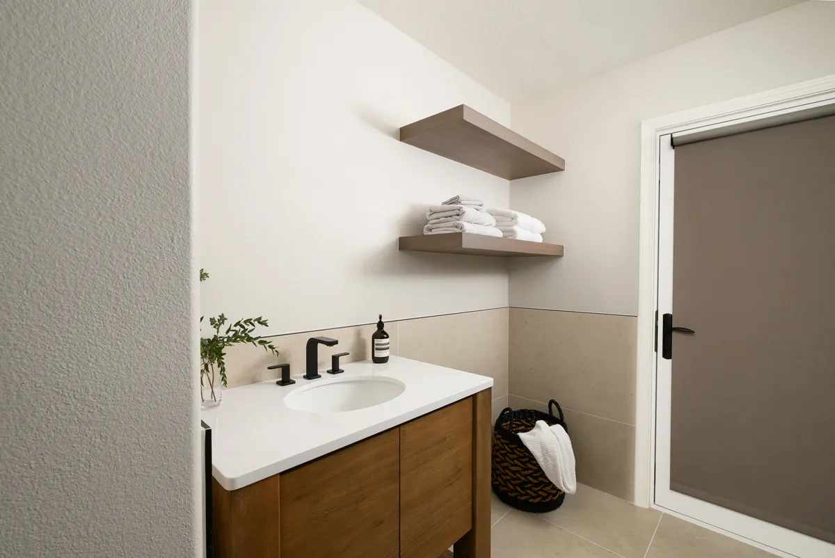 glazed-porcelain-creme-flooring-and-matching-wainscoting-wall-coverings-throughout-laundry-room