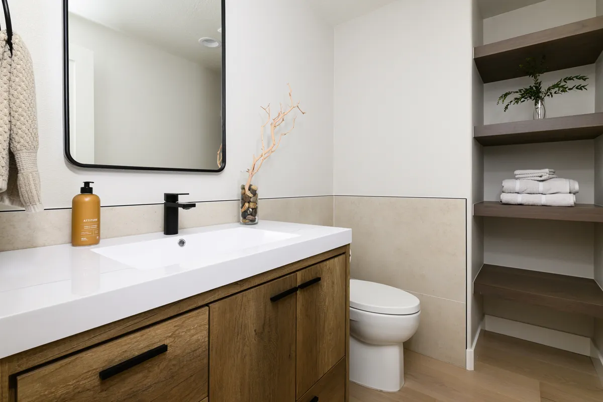 powder-bath-Kemper-cabinets-in-Natural-Oak-finish-with-polished-quartz-countertops-in-Aurum-matte-black-faucet-plus-omega-linen-closet-shelving