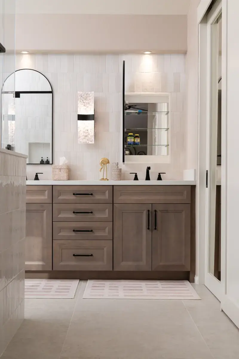 matte-black-arched-mirror-medicine-cabinets-sit-above-white-undermount-sinks