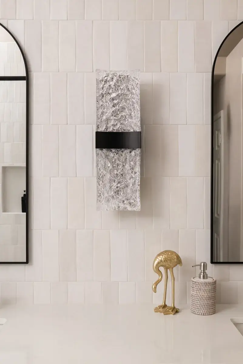 Lava-black-LED-wall-sconce-sits-on-verticle-subway-glazed-ceramic-tile-backsplash-in-cloe-glossy-white-finish
