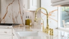 Waterstone-traditional-pulldown-faucet-with-lever-handles-in-polished-brass