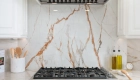 custom-white-curved-decorative-appliance-hood-with-brass-strappings