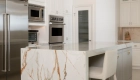 polished-Dekton-island-countertops-in-Awake-finish-with-waterfall-sides