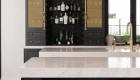 custom-bar-area-includes-brass-mesh-grill-covers-and-decorative-vintage-brass-Cremone-bolts-with-oval-knobs-and-marble-mosaic-backsplash-in-China-Black