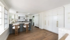 upper-cabinets-and-paneled-fridge-and-freezer-and-pantry-cabinets-in-Kemper-maple-wood-in-Painted-Coconut-finish
