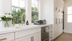 undermount-sink-with-satin-brass-high-spout-kitchen-faucet-in-back-kitchen