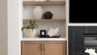 Omega-cabinets-and-shelving-in-Riverbed-finish-were-framed-into-new-arched-recessed-wall