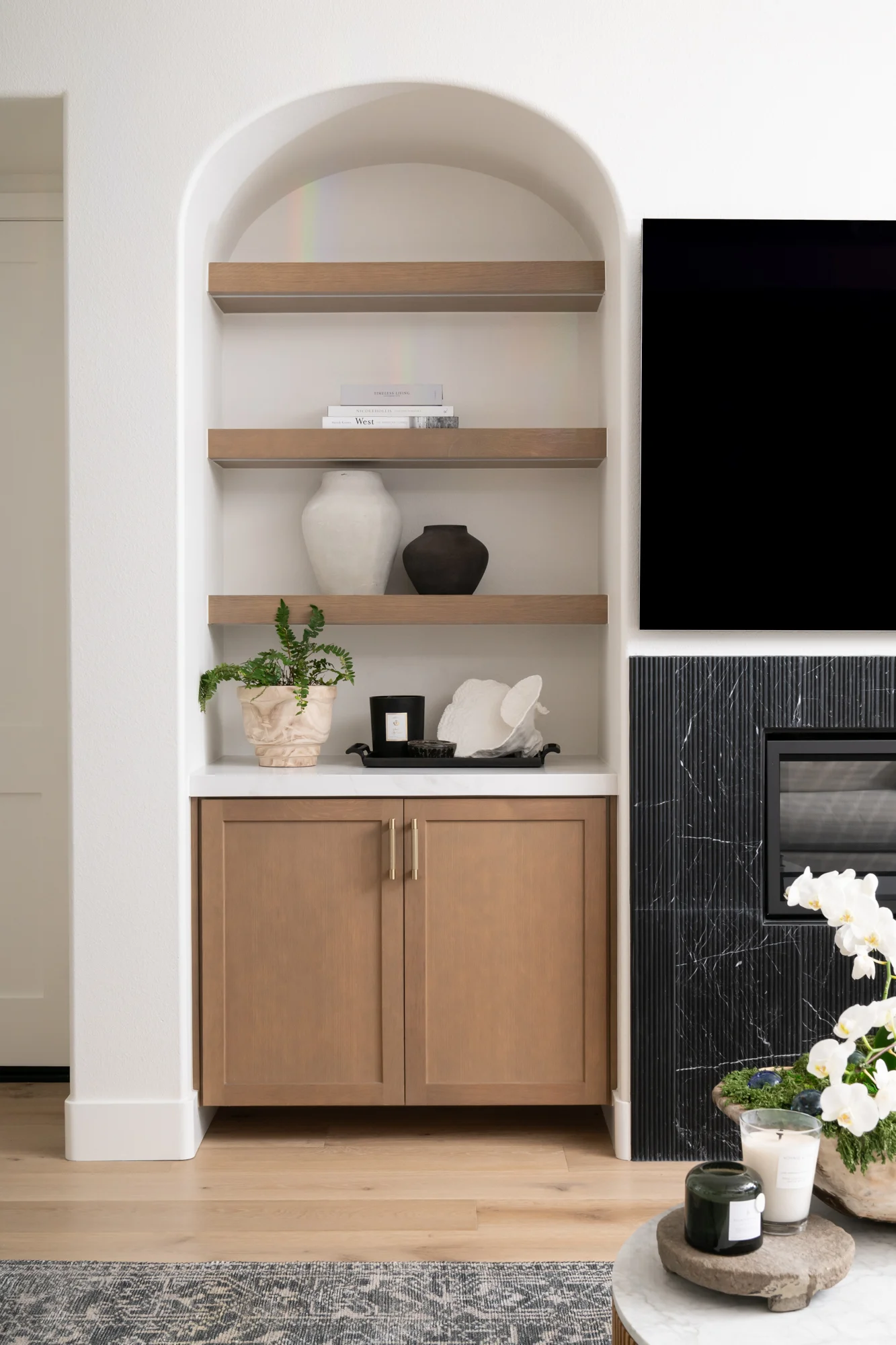 Omega-cabinets-and-shelving-in-Riverbed-finish-were-framed-into-new-arched-recessed-wall