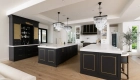 the-two-islands-and-bar-cabinetry-by-Omega-in-a-custom-paint-color-with-brass-inlays-on-end-panels