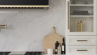 both-kitchens-have-polished-quartz-countertops-in-Sterling-Light-and-porcelain-tile-backsplash-in-Polished-Luna-finish