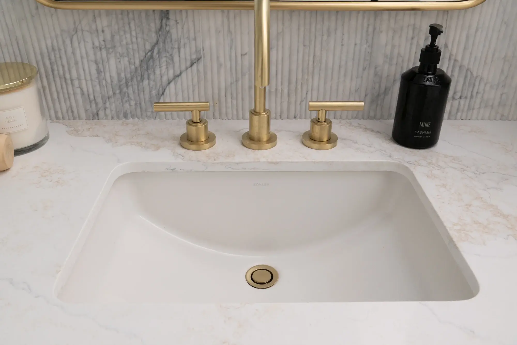 dual-vanities-include-white-undermount-sinks-with-widespread-lavatory-faucets-metal-framed-mirros-and-dual-sconces-in-satin-brass