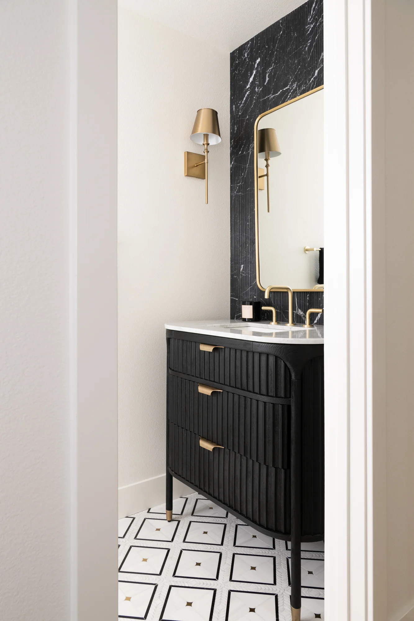 powder-bath-remodel-with-full-wall-marble-tile-backsplash-by-Waves-series-in-Nero-finish-and-marble-tile-flooring-in-Calcatta-tulip-black