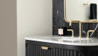 Marble-top-fluted-wood-single-bathroom-vanity-with-sink-and-widespread-lavatory-faucet-and-framed-mirror