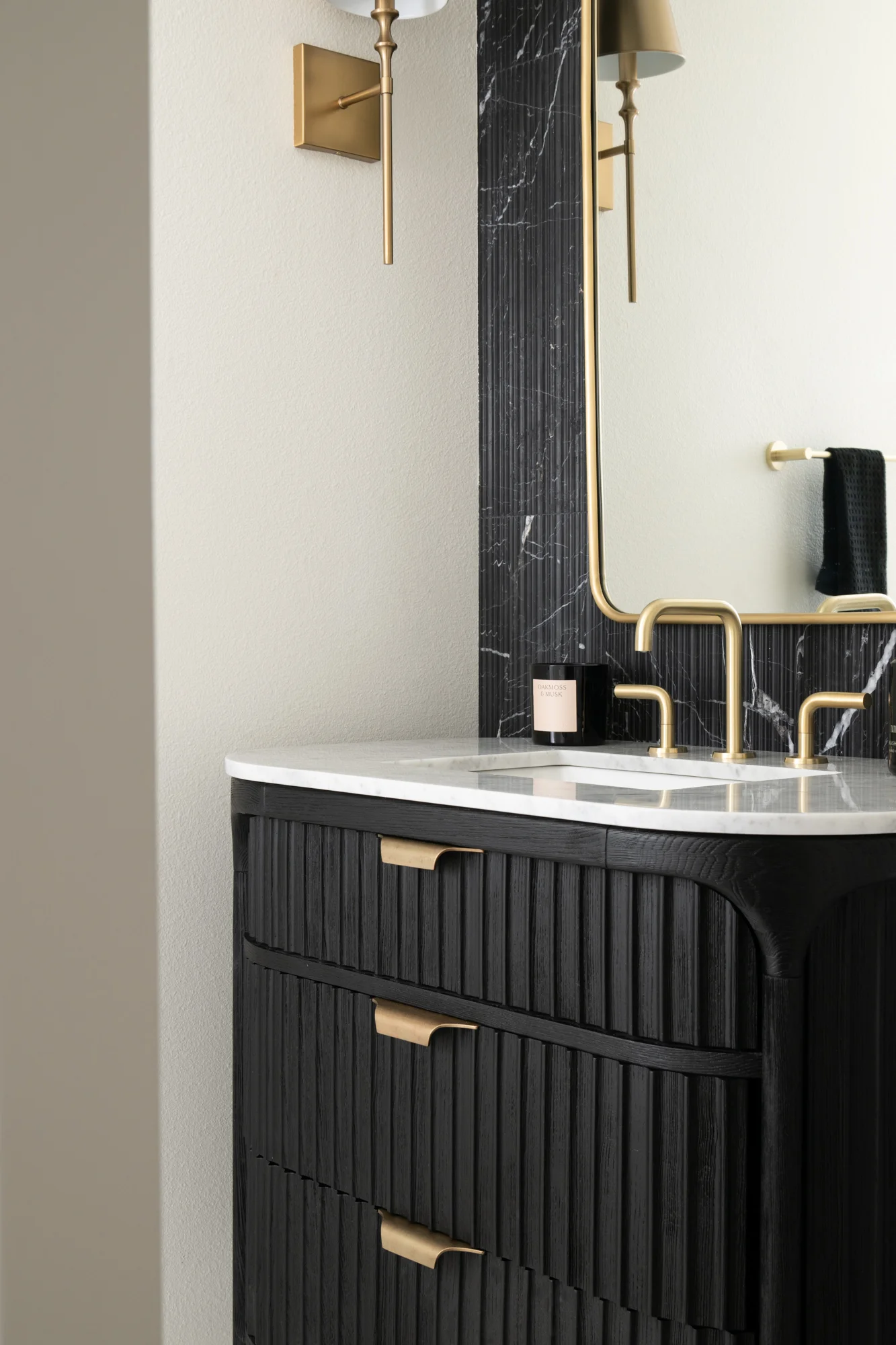 Marble-top-fluted-wood-single-bathroom-vanity-with-sink-and-widespread-lavatory-faucet-and-framed-mirror